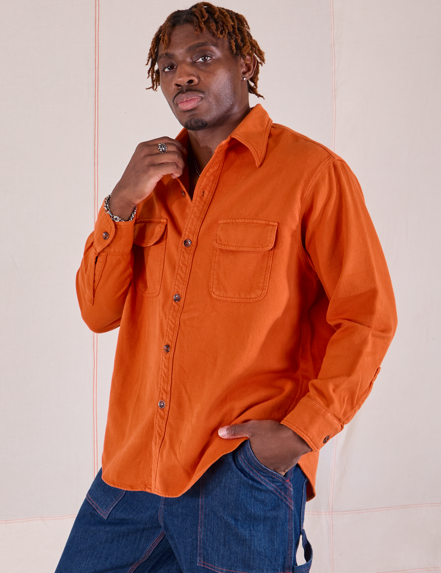 Angled front view of Flannel Overshirt in Burnt Orange on Isaac