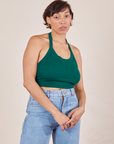 Tiara is 5'4" and wearing XS Halter Top in Hunter Green paired with light wash Sailor Jeans