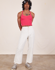 Jerrod is wearing a Halter Top in Hot Pink and vintage off-white Western Pants