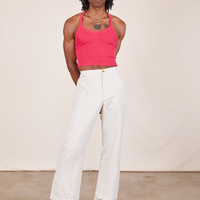 Jerrod is wearing a Halter Top in Hot Pink and vintage off-white Western Pants