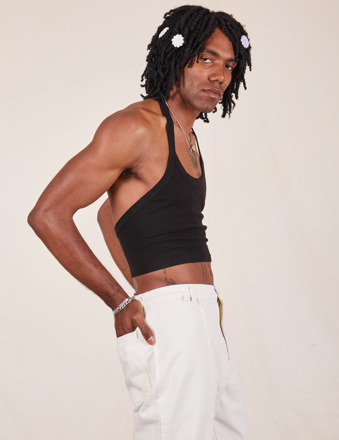 Side view of Halter Top in Basic Black and vintage off-white Western Pants worn by Jerrod