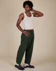 Angled front view of Heavyweight Trousers in Swamp Green and Tank Top in Vintage Tee Off-White on Jerrod