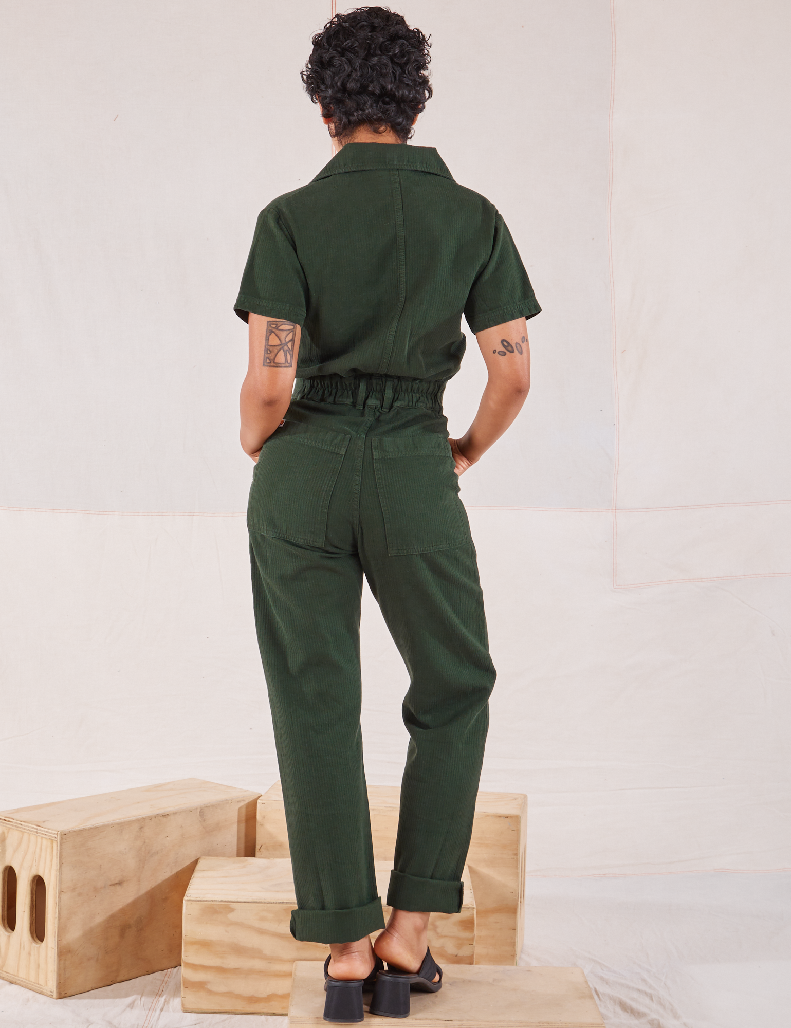 Heritage Short Sleeve Jumpsuit in Swamp Green back view on Mika