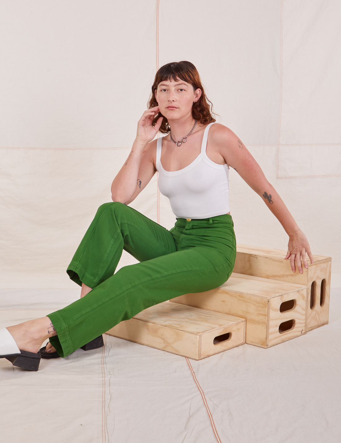 Alex is wearing Heritage Westerns in Lawn Green and vintage off-white Cropped Cami