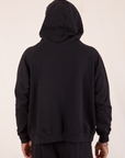 Oversized Hoodie in Basic Black with hood up back view on Issac