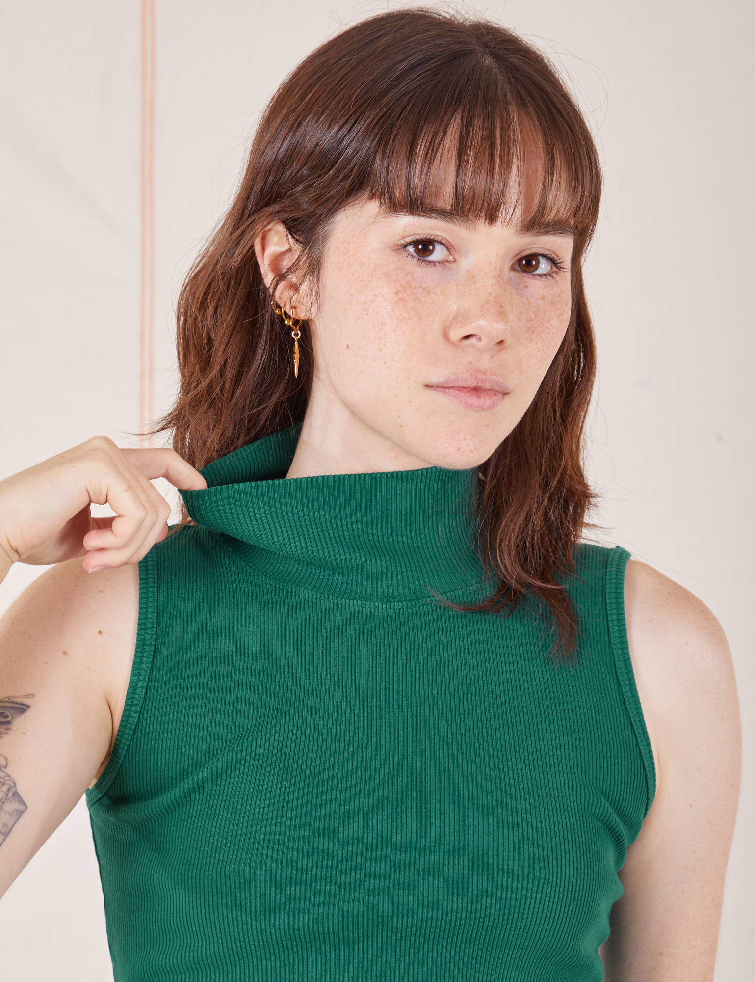 Front close up of Sleeveless Essential Turtleneck in Hunter Green on Hana