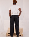 Back view of Mid-Rise Pleated Trousers in Basic Black and Organic Vintage Tee in vintage tee off-white on Issac