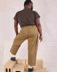 Back view of Mid-Rise Pleated Trousers in Desert Brown and espresso brown Organic Vintage Tee