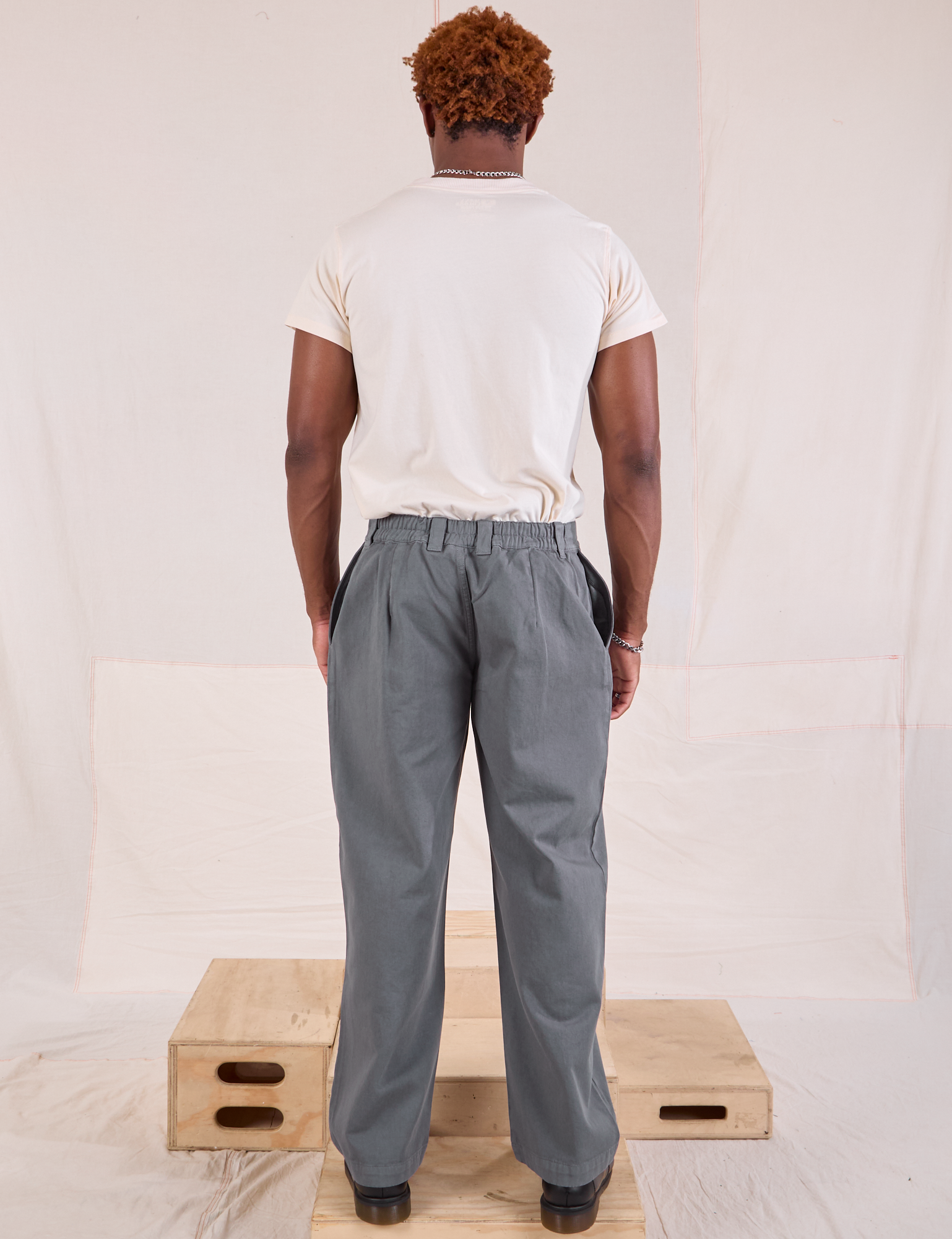 Back view of Mid-Rise Pleated Trousers in Slate Grey and Organic Vintage Tee in vintage tee off-white on Issac