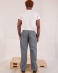 Back view of Mid-Rise Pleated Trousers in Slate Grey and Organic Vintage Tee in vintage tee off-white on Issac