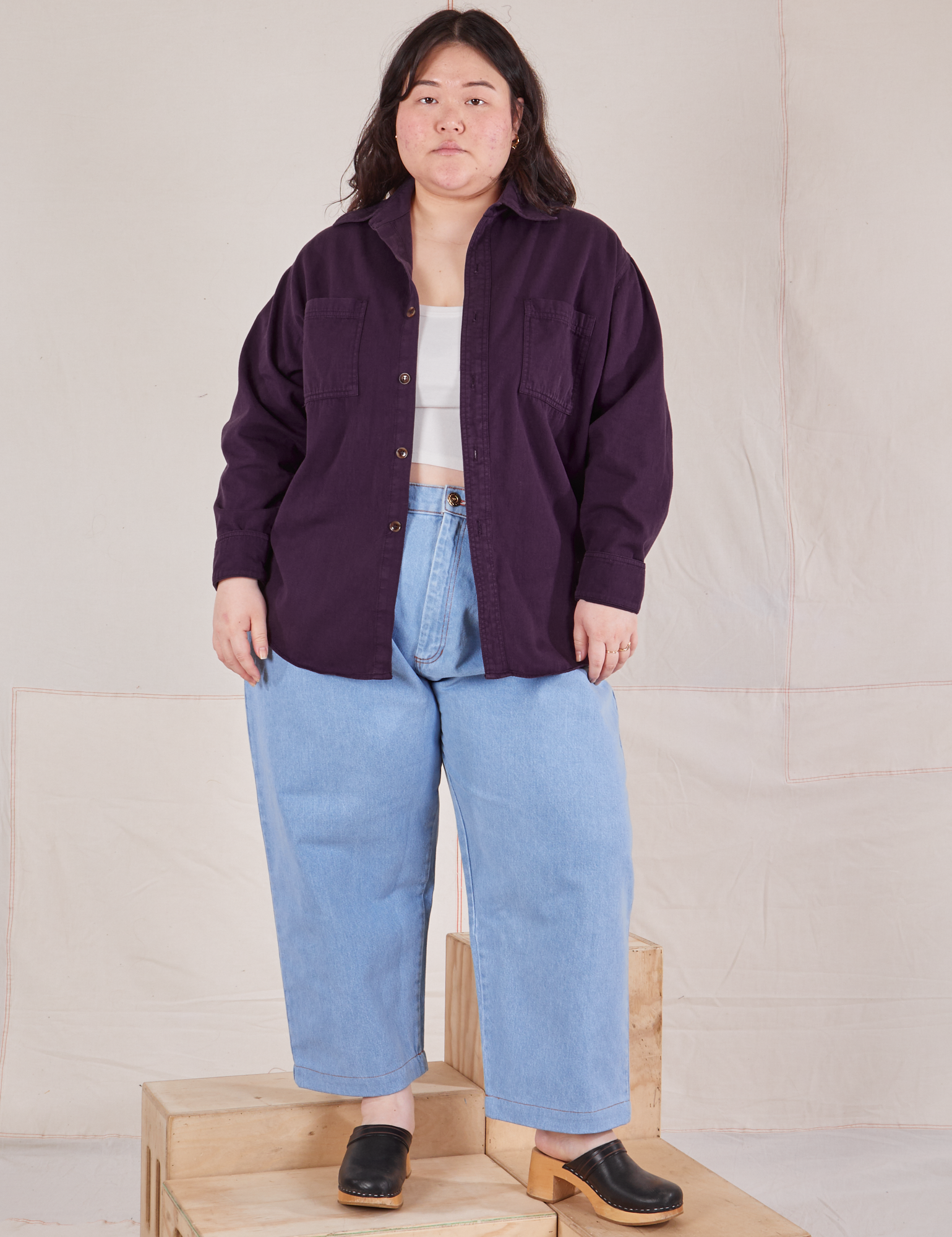 Ashley is wearing Oversize Overshirt in Nebula Purple and light wash Trouser Jeans