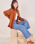 Side view of Oversize Overshirt in Burnt Terracotta and light wash Sailor Jeans worn by Hana