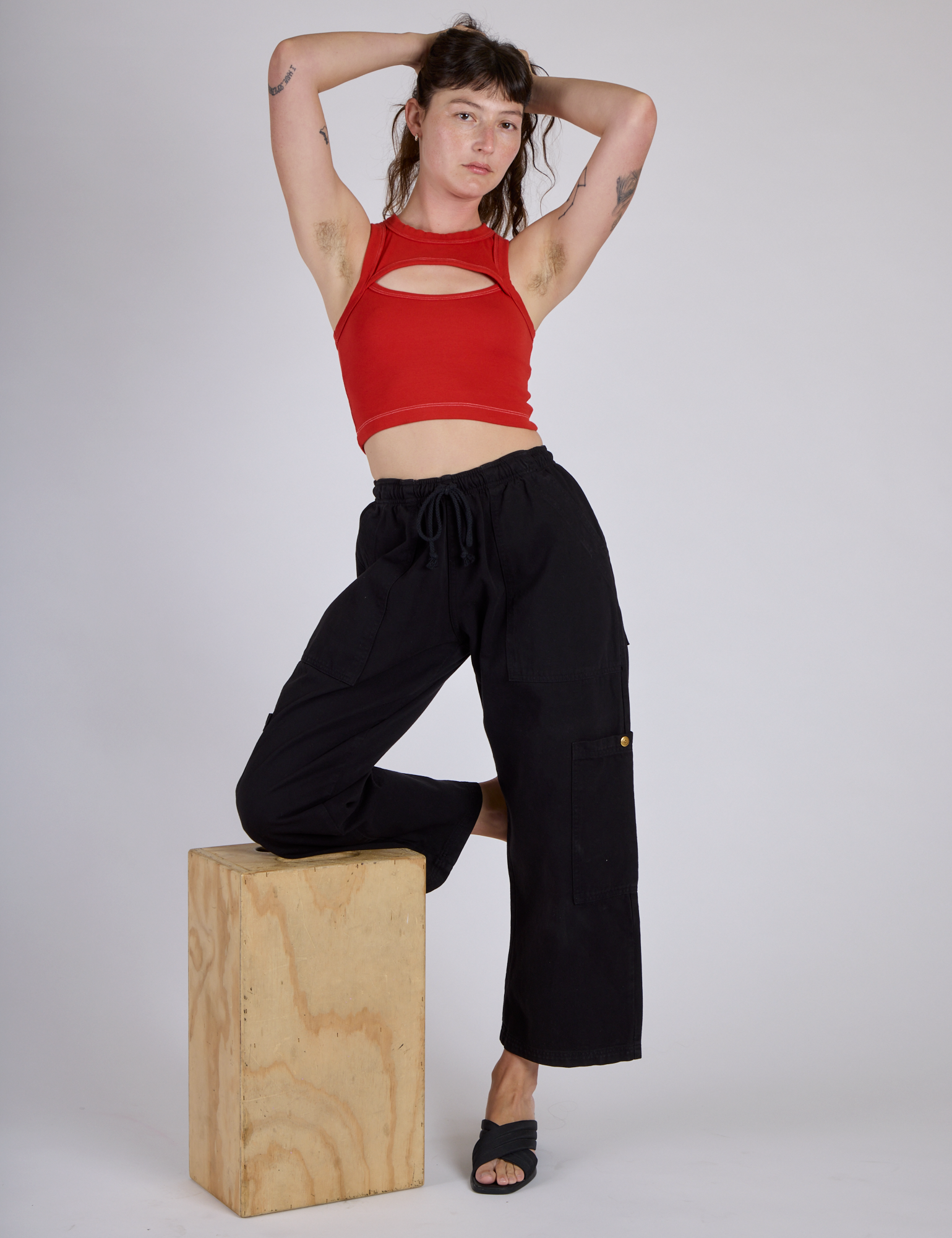 Alex wearing the Mustang Red Porthole Tank and Black Drop Pocket Cargo Pant