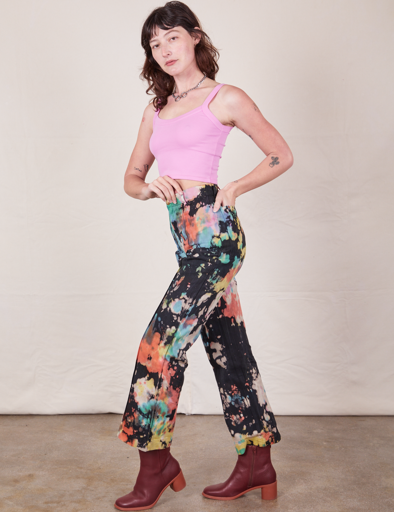 Western Pants in Rainbow Magic Waters side view of Western Pants in Rainbow Magic Waters and bubblegum pink Cami on Alex