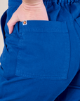 Short Sleeve Jumpsuit in Royal Blue back pocket close up with Alex's hand in the pocket.