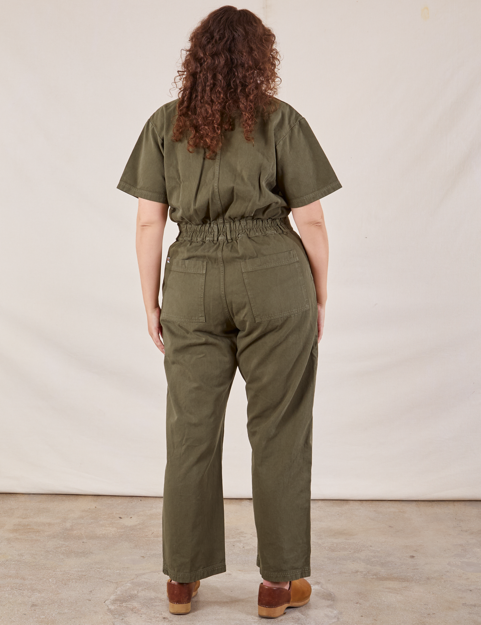 Short Sleeve Jumpsuit in Surplus Green back view on Ryan