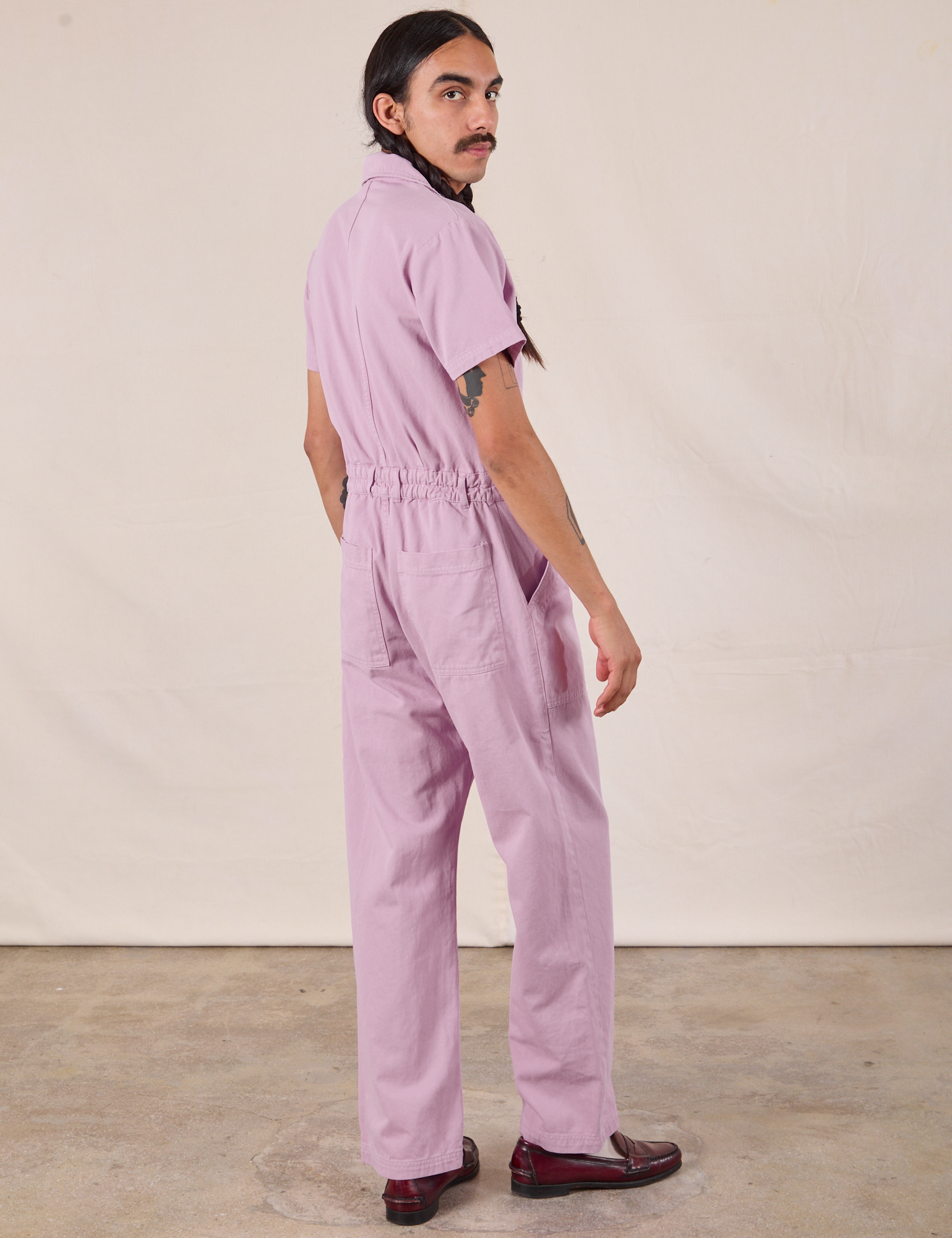 Short Sleeve Jumpsuit in Lilac angled back view on Anthony