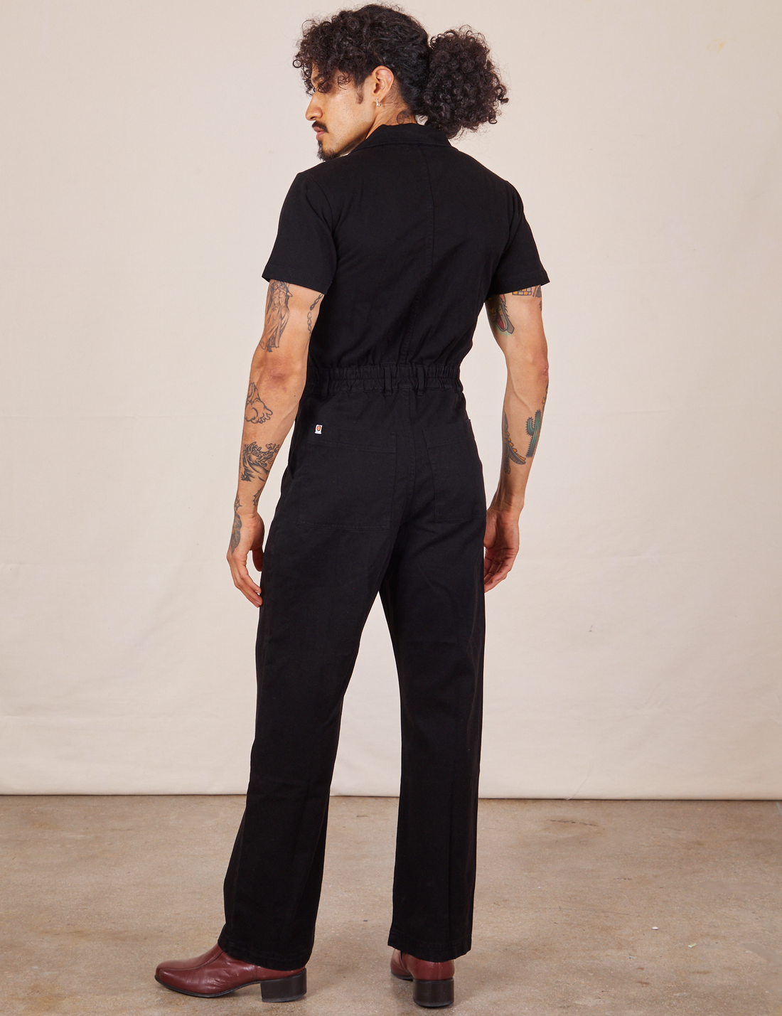 Back view of Short Sleeve Jumpsuit in Basic Black worn by Jesse
