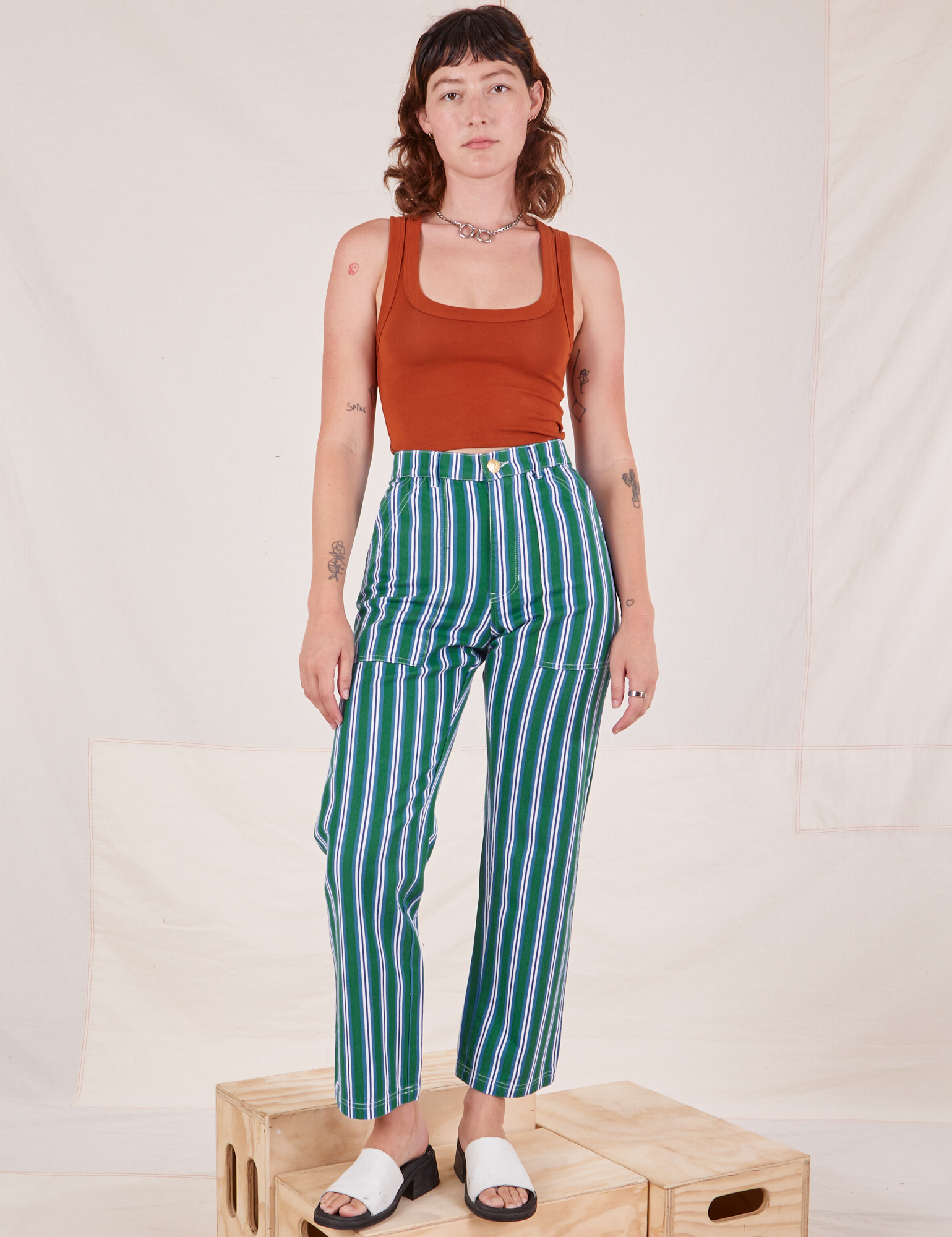 Alex is 5&#39;8&quot; and wearing XS Stripe Work Pants in Green paired with burnt terracotta Cropped Tank Top