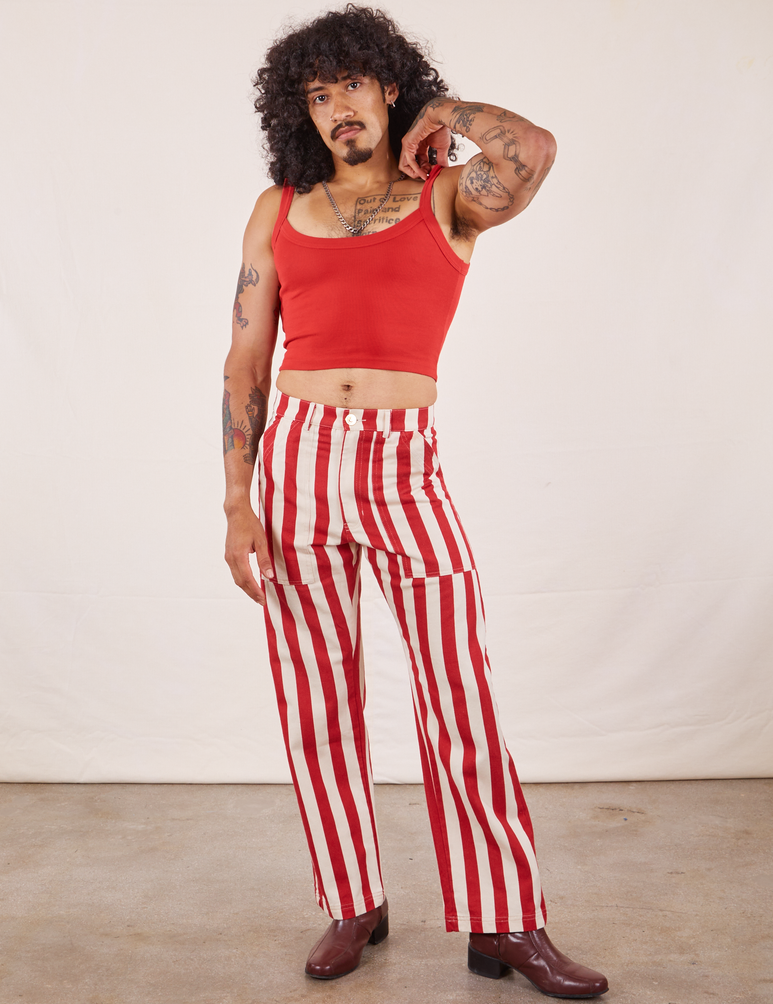 Jesse is 5&#39;8&quot; and wearing XS Work Pants in Cherry Stripe paired with mustang red Cropped Cami
