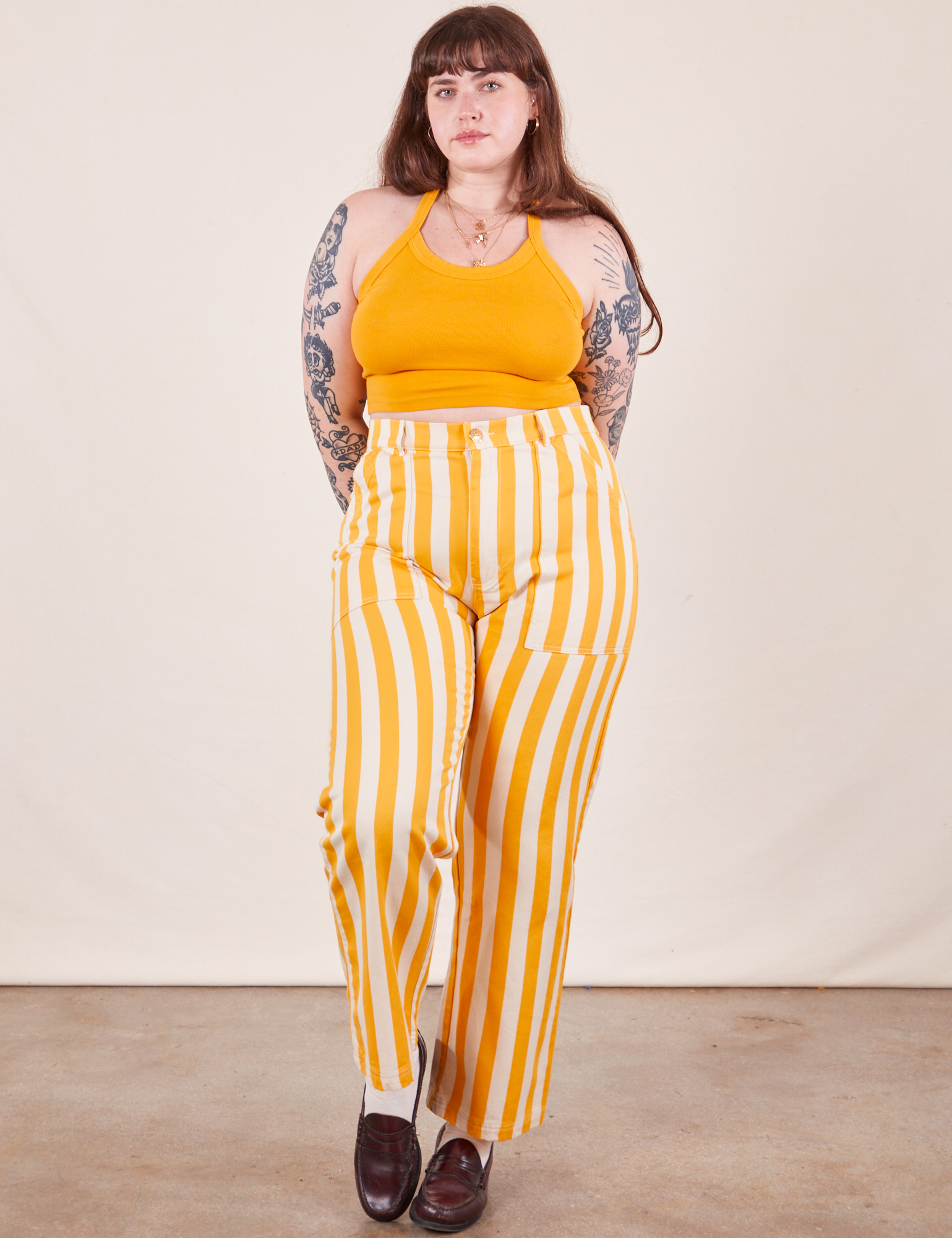 Sydney is 5&#39;9&quot; and wearing L Work Pants in Lemon Stripe paired with mustard yellow Halter Top