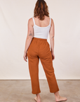 Back view of Cropped Rolled Cuff Sweatpants in Burnt Terracotta and vintage off-white Cami on Alex