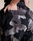 Close up of Alex's hand in the back pocket of Magic Waters Drop Pocket Pants in Ink Blot