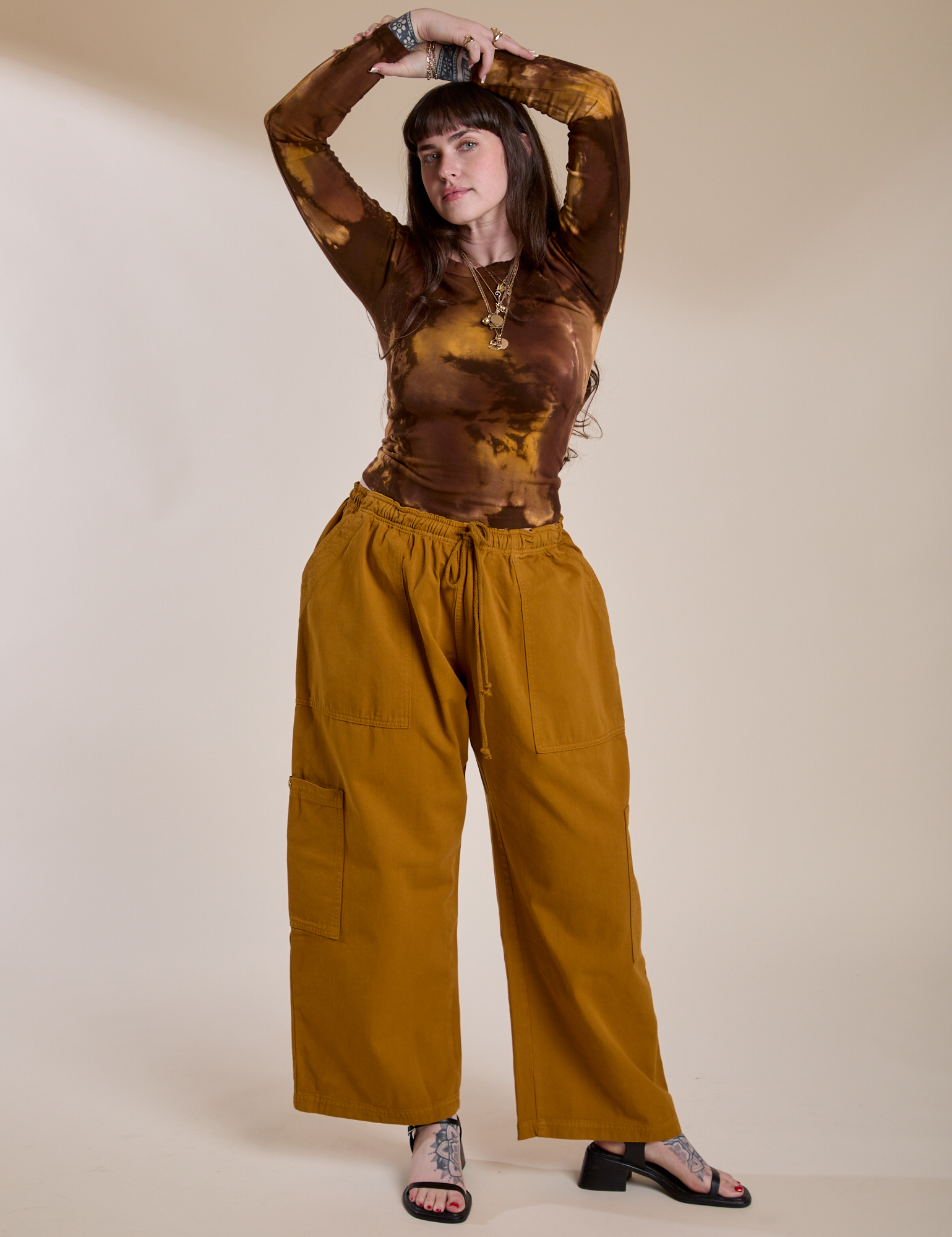 Sydney is wearing Long Sleeve Baby Tee in Honey Brown and spicy mustard Drop Pocket Cargo Pants