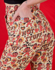Close up of Alex's hand in the back pocket of Work Pants in Hot Stuff Print 
