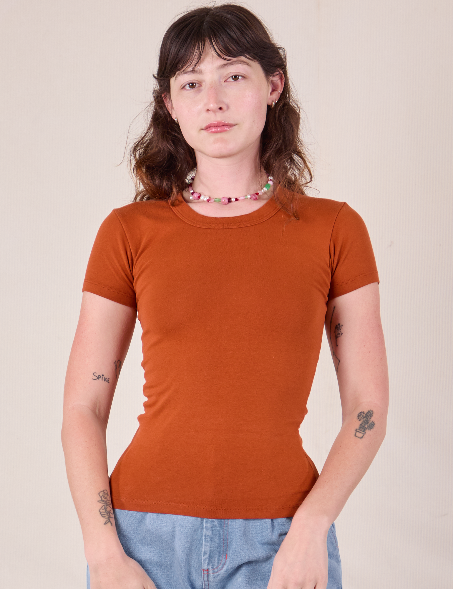 Alex is wearing Baby Tee in Burnt Terracotta