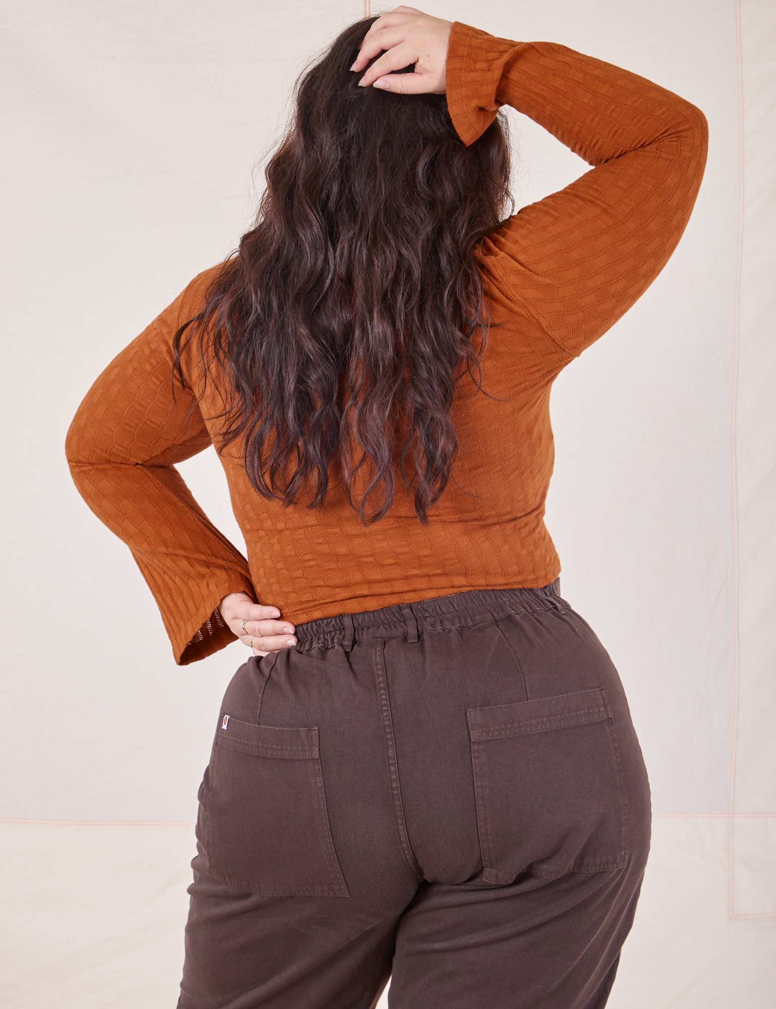 Back view of Bell Sleeve Top in Burnt Terracotta and espresso brown Western Pants worn by Ashley