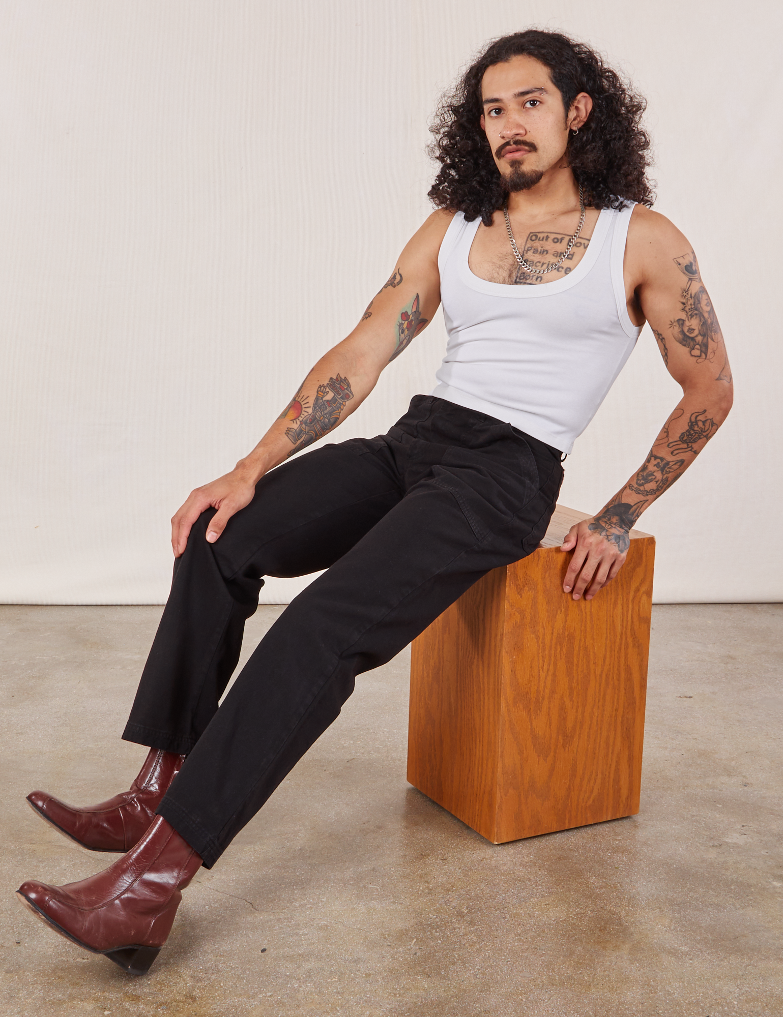 Jesse is wearing Work Pants in Black and Cropped Tank in vintage tee off-white