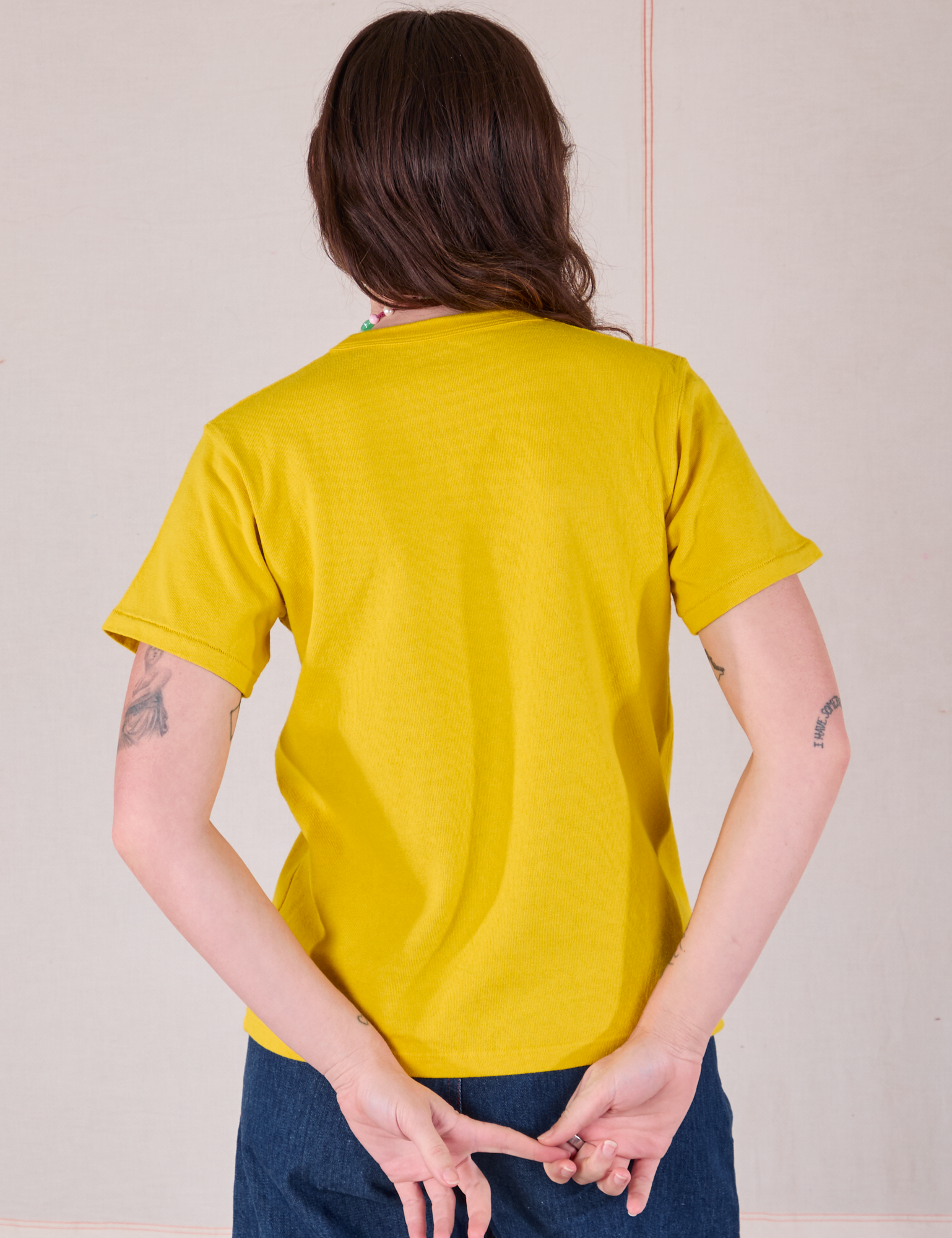 Burly Tee in Golden Yellow back view on Alex