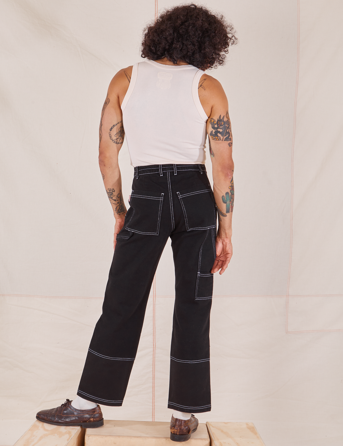 Back view of Carpenter Jeans in Black worn by Jesse