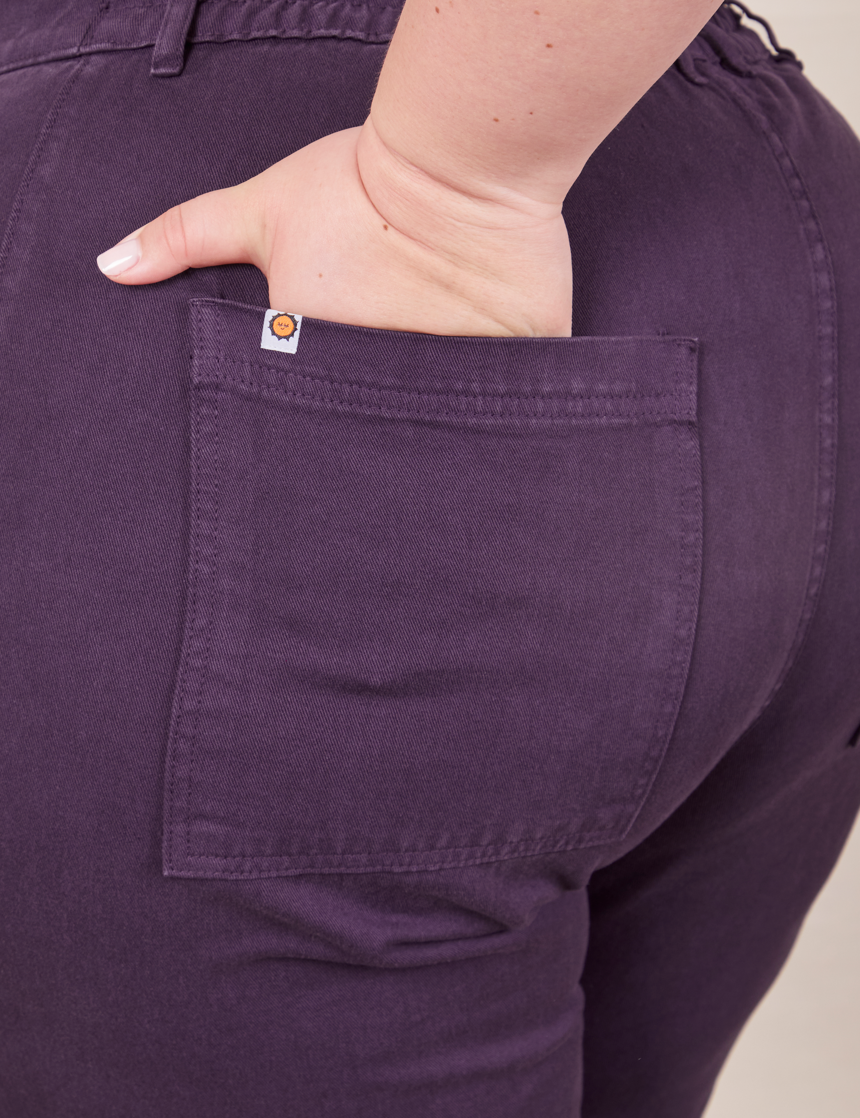 Back pocket close up of Petite Work Pants in Nebula Purple worn by Ashley