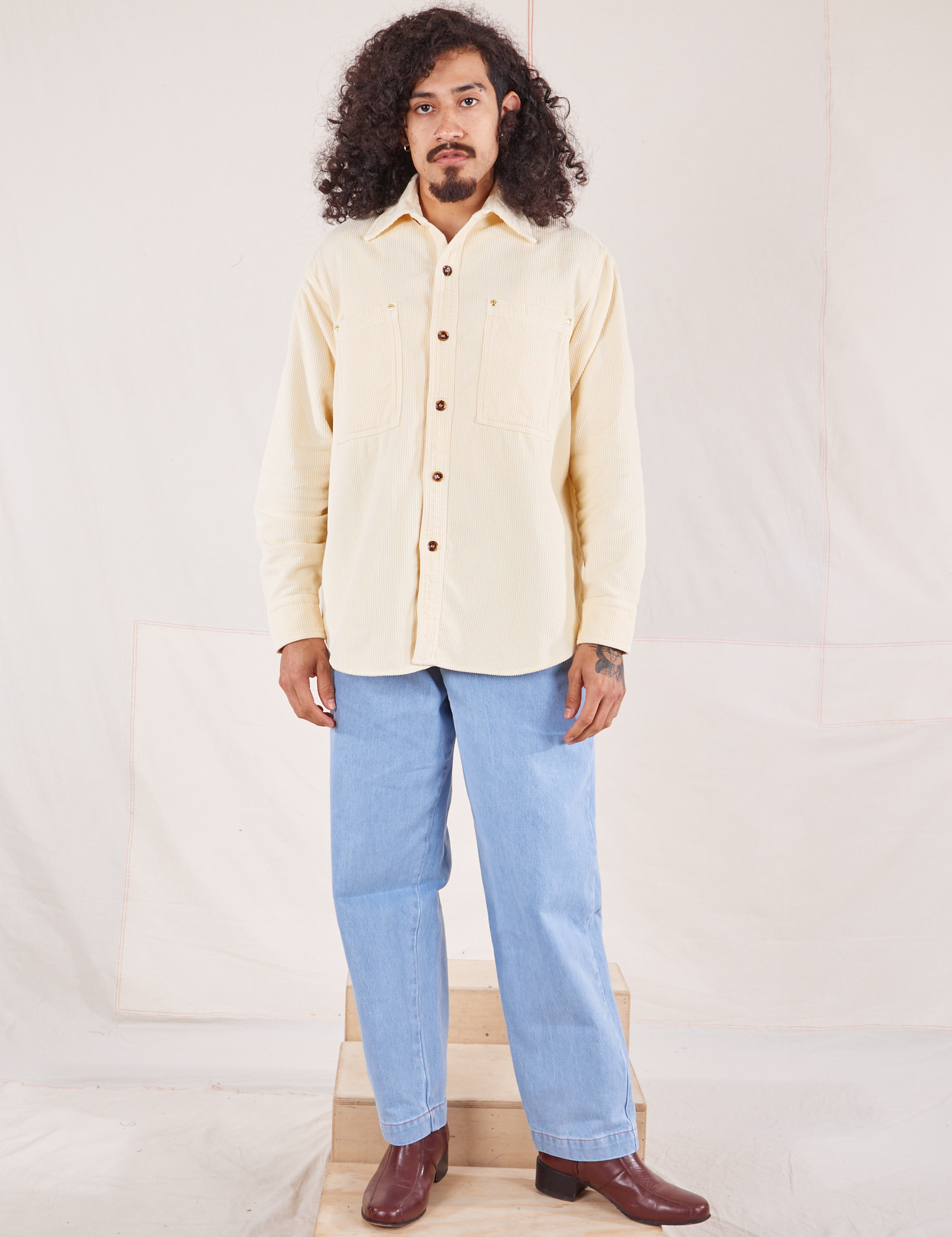 Jesse is 5&#39;8&quot; and wearing XS Corduroy Overshirt in Vintage Off-White paired with light wash Denim Trouser Jeans