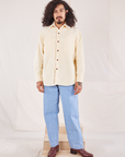 Jesse is 5'8" and wearing XS Corduroy Overshirt in Vintage Off-White paired with light wash Denim Trouser Jeans