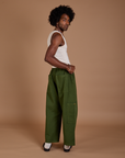 Angled back view of Drop Pocket Cargo Pants in Evergreen on Jerrod