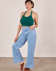 Tiara is wearing Halter Top in Hunter Green and light wash Sailor Jeans