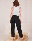 Back view of Heavyweight Trousers in Basic Black and vintage off-white Cropped Tank Top worn by Alex.