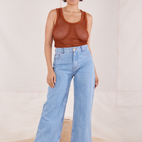 Tiara is wearing Mesh Tank Top in Burnt Terracotta and light wash Sailor Jeans
