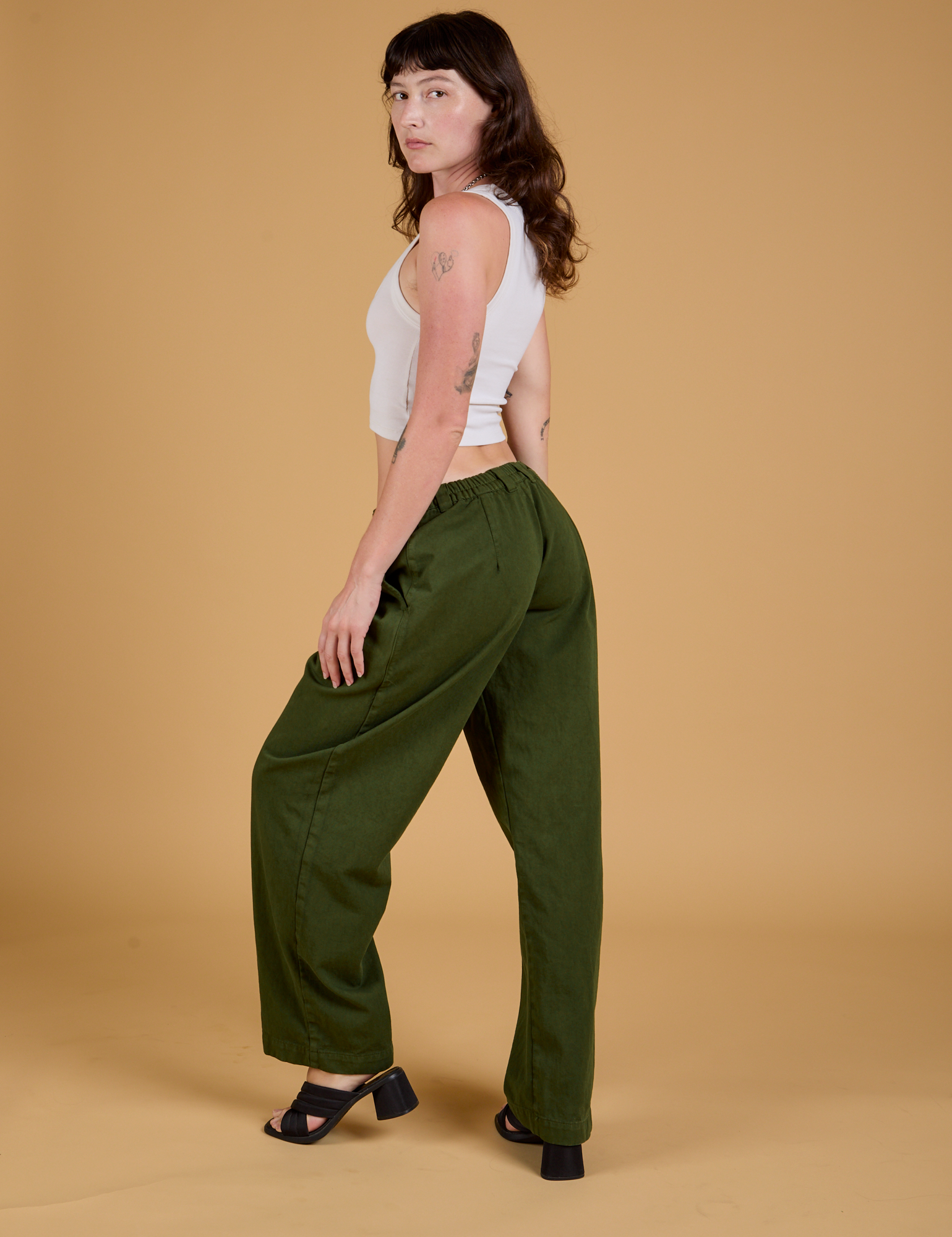 Angled back view of Baggy Mid-Rise Trousers in Evergreen on Alex
