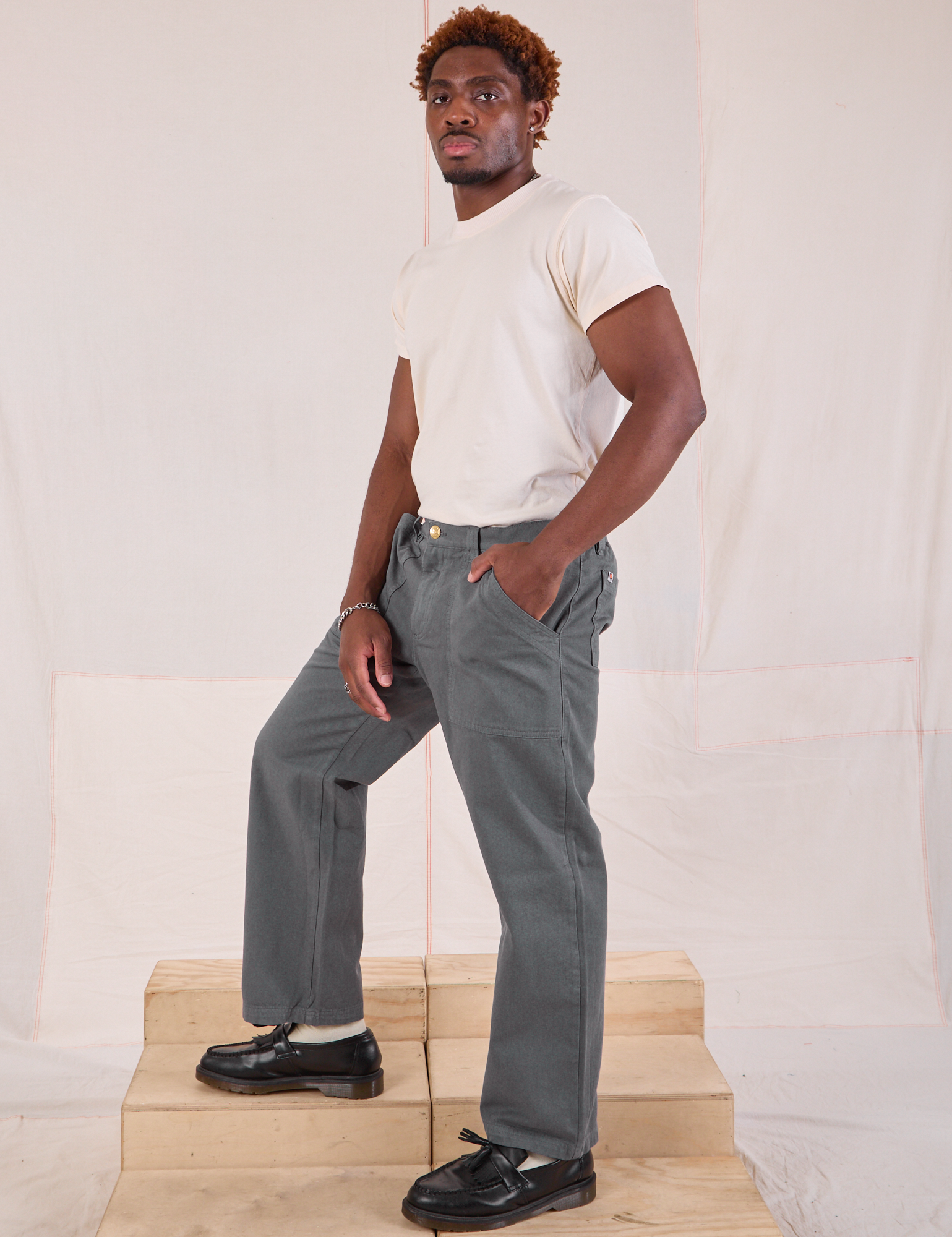 Side view of Mid-Rise Work Pants in Slate Grey and Organic Vintage Tee in vintage tee off-white on Issac