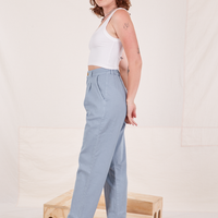 Side view of Organic Trousers in Periwinkle and vintage off-white Cami worn by Alex