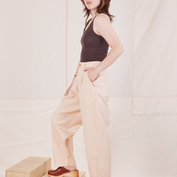 Side view of Heritage Trousers in Vintage Off-White and espresso brown Tank Top worn by Hana