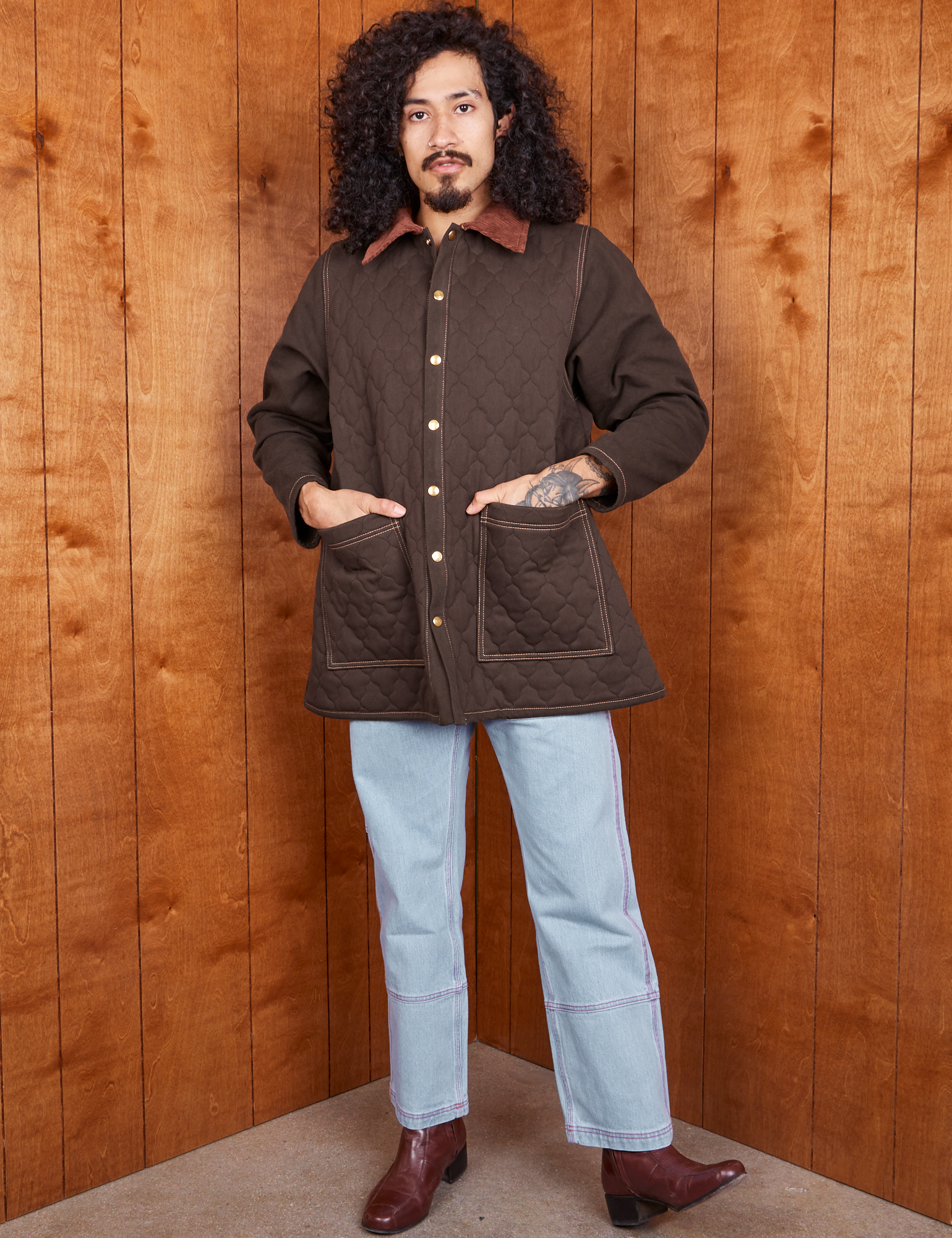 Jesse is 5&#39;8&quot; and wearing XS Quilted Overcoat in Espresso Brown paired with light wash Carpenter Jeans