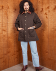 Jesse is 5'8" and wearing XS Quilted Overcoat in Espresso Brown paired with light wash Carpenter Jeans