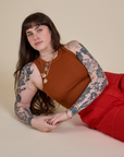 Sydney is wearing Racerback Tank in Burnt Terracotta