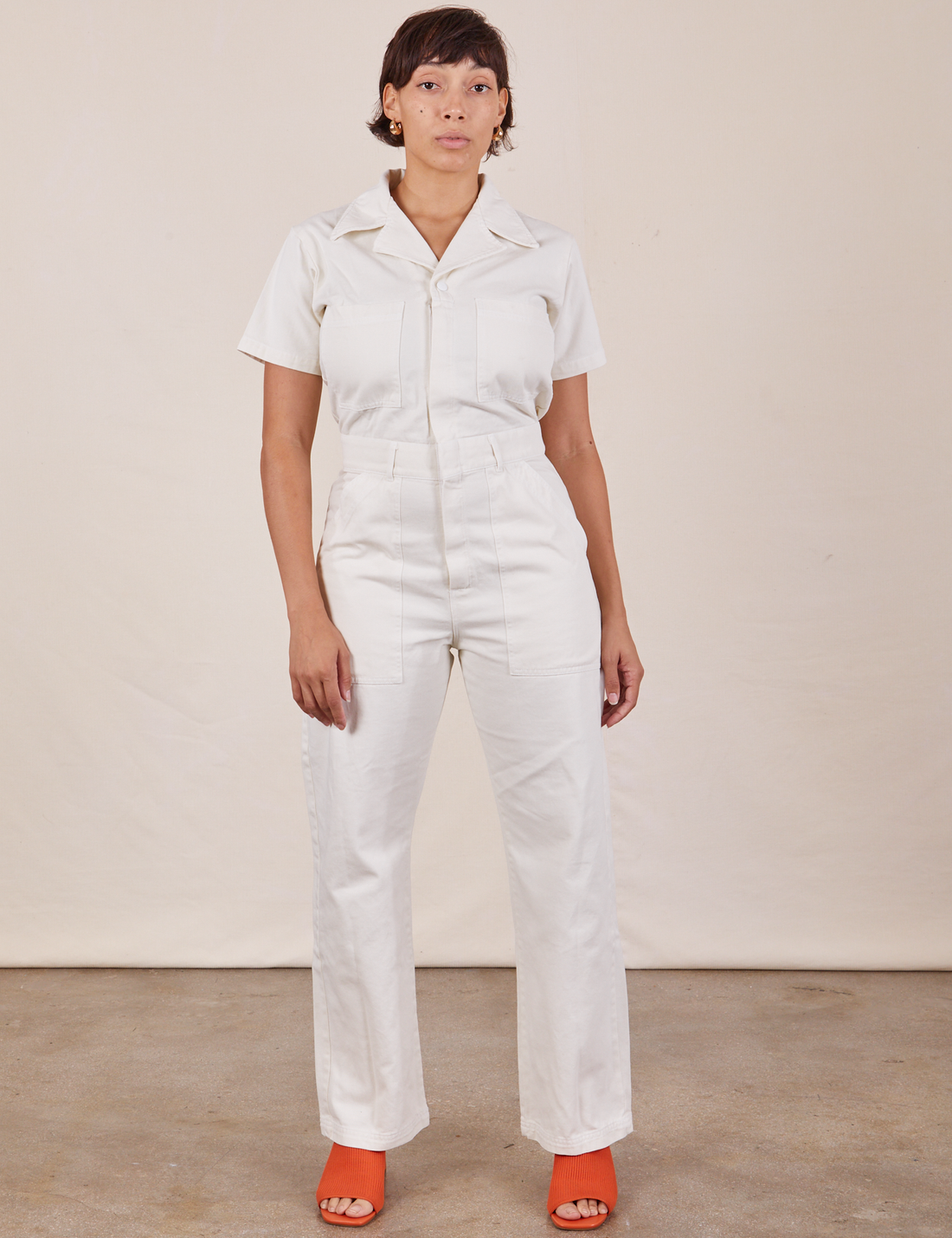 Tiara is 5'4" and wearing S Short Sleeve Jumpsuit in Vintage Tee Off-White