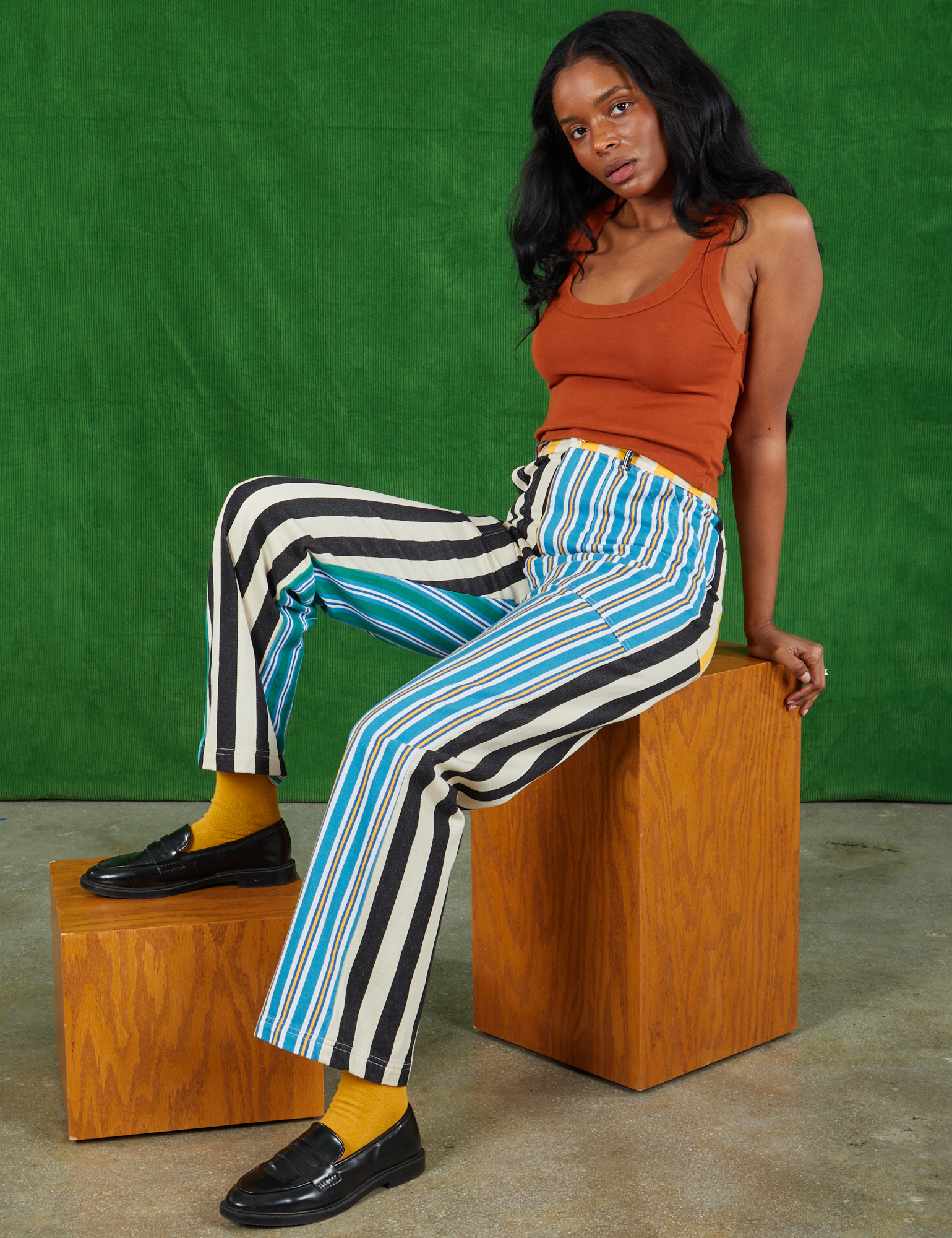Kandia is wearing Mismatched Stripe Work Pants and burnt terracotta Cropped Tank Top